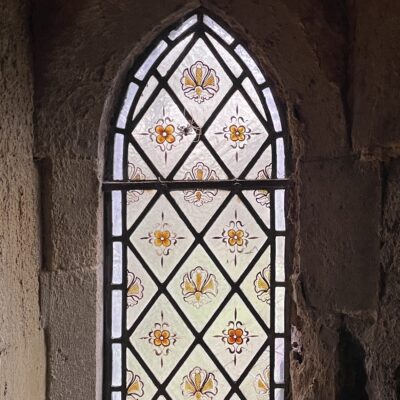 Victorian lancet shaped stained glass window with decorative hand painted fleur de lys