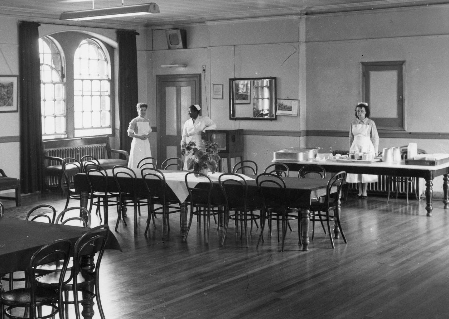 Nurses in a 1950s ward at Glenside Hospital, with tables dressed ready for meal time